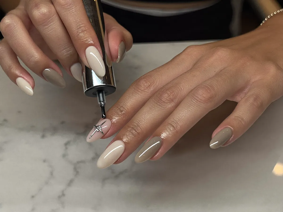 Gel manicure detail on the marble table